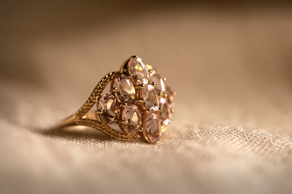 A gold ring with a cluster of peach morganites