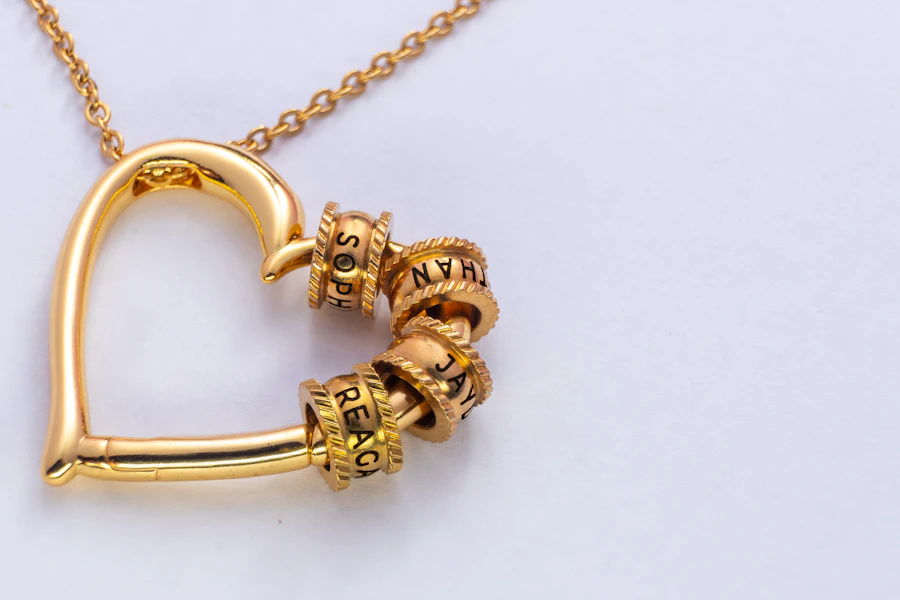 Gold heart pendant necklace with engraved charm beads